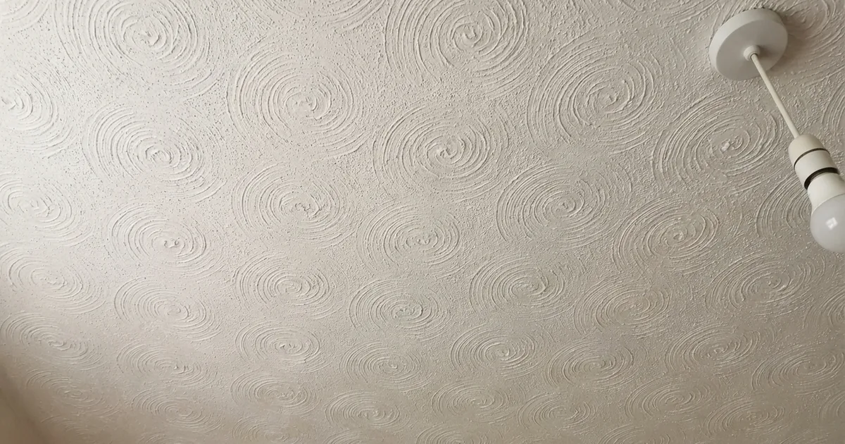 Textured Artex ceiling with swirl pattern in a UK home, typical of 1970s and 1980s construction