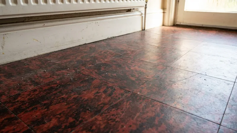 Dark red and black 9x9 inch vinyl floor tiles from a 1970s UK kitchen, a common asbestos-containing material